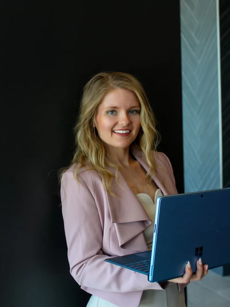 Willow Waldock, CPA, founder of WJ CPA PLLC in Fort Worth, holding a laptop